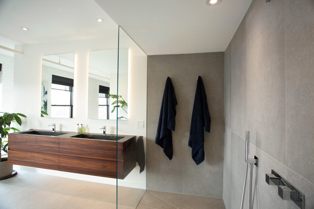 a modern bathroom renovation result with a wet room and walk-in shower