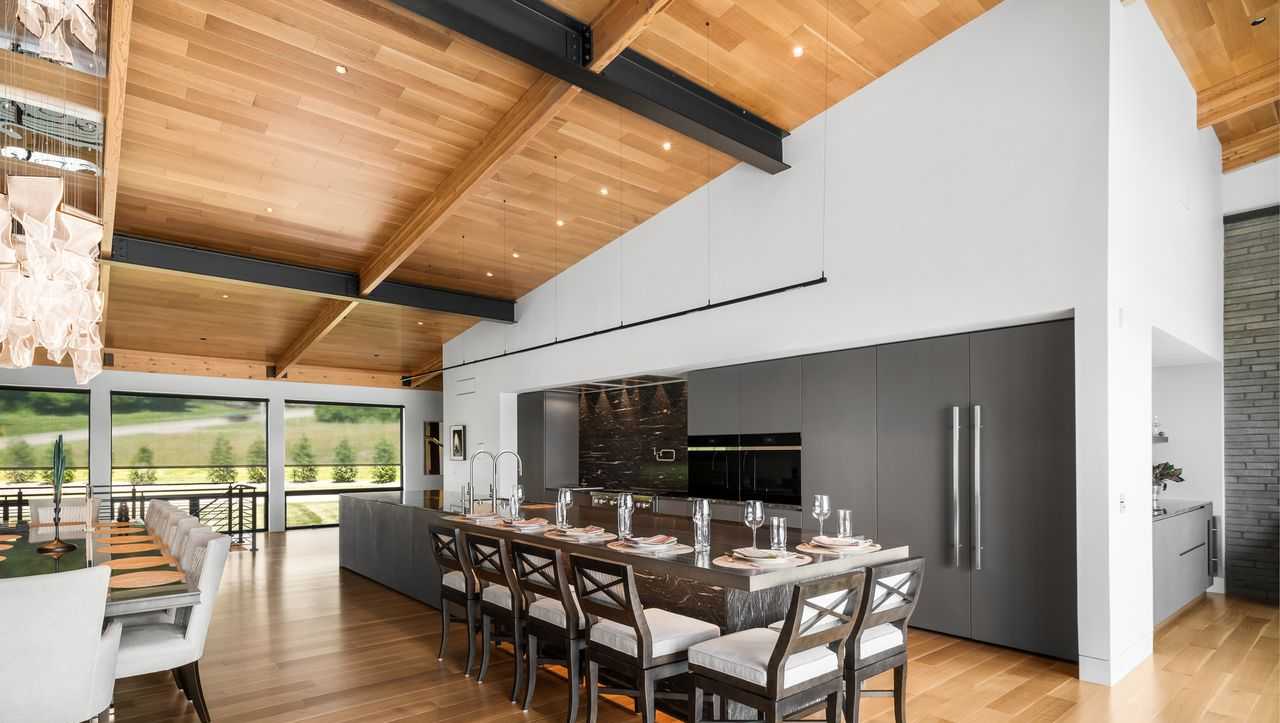 Serene modern kitchen with granite kitchen island and integrated appliances