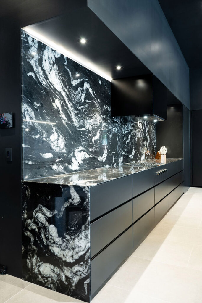 Luxury kitchen with full-height stone backsplash