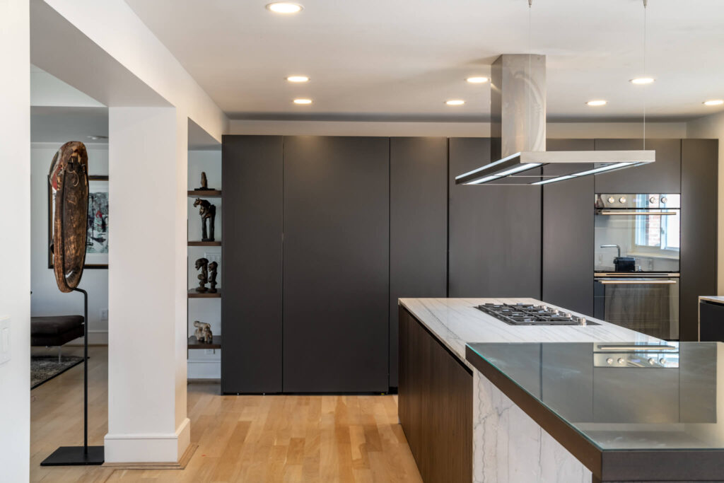 suspended hood over kitchen island in a monolithic kitchen